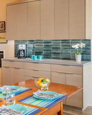 a kitchen with a wooden table with glasses on it at Seahorse Cottage by Paradise Retreats in Carpinteria