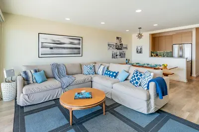 a living room with a couch and a table at Seahorse Retreat by Paradise Retreats in Carpinteria