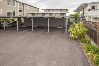 a large concrete patio with a large table in front of a house at Seahorse Retreat by Paradise Retreats in Carpinteria