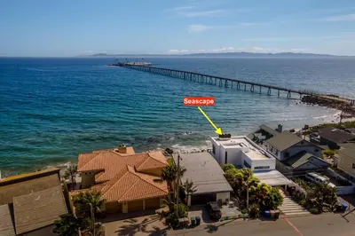 an aerial view of a beach with a pier at Seascape by Paradise Retreats in Carpinteria