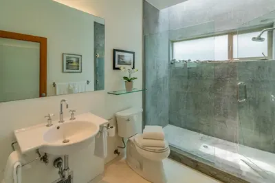 a bathroom with a toilet and a sink and a shower at Seascape by Paradise Retreats in Carpinteria