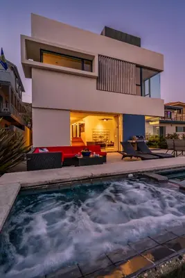 a house with a swimming pool in front of a house at Seascape by Paradise Retreats in Carpinteria