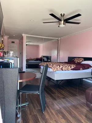 a bedroom with a bed and a table with chairs at Just The Two Of Us -Romantic Pool View And Private Entry Sleeps 2 Near CSUN CSUN in North Hills