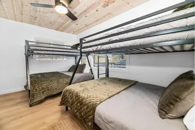 two beds in a room with two loft beds at Newly Renovated Villa 6 Beds Fenced-in Backyard in Big Bear Lake