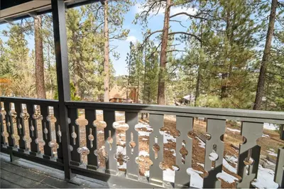 a balcony with a view of the trees at Newly Renovated Villa 6 Beds Fenced-in Backyard in Big Bear Lake