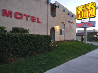 a motel sign in front of a building with a motel sign at Crzy 8 Motel in Orange