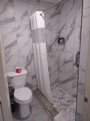 a bathroom with a toilet and a shower at Crzy 8 Motel in Orange