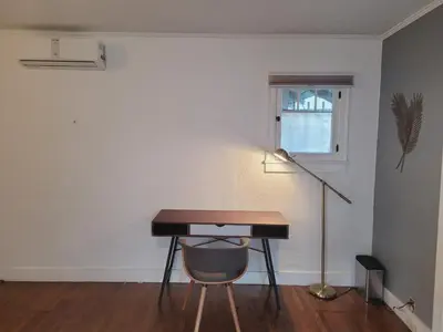 a desk with a chair and a lamp in a room at Spacious Studio Six in Hollywood! in Los Angeles