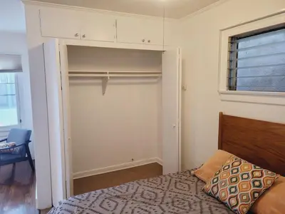 a bedroom with a closet with a bed and a window at Spacious Studio Six in Hollywood! in Los Angeles