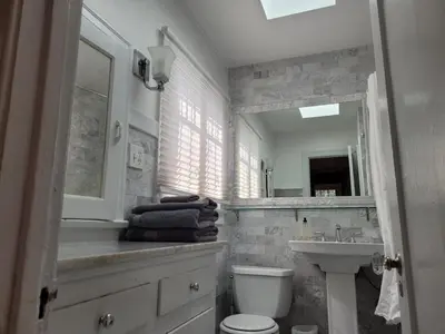 a bathroom with a sink and a toilet and a mirror at Hollywood Bungalow One with Patio! in Los Angeles