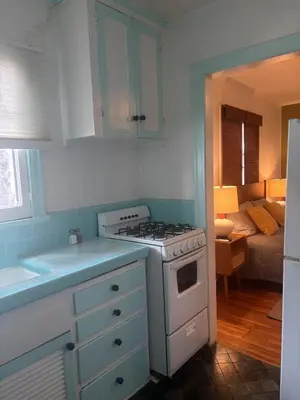 a kitchen with a stove and a room with a bed at Hollywood Bungalow One with Patio! in Los Angeles