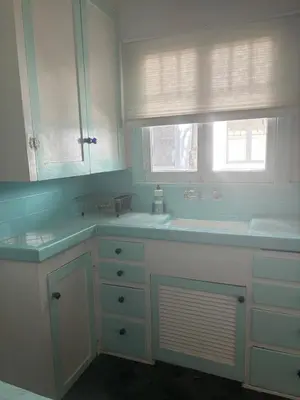a white bathroom with two sinks and a mirror at Hollywood Bungalow One with Patio! in Los Angeles