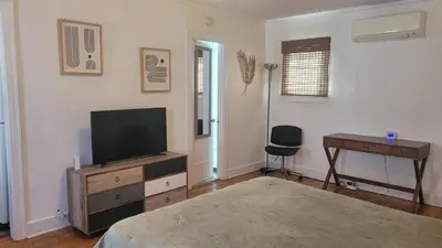 a bedroom with a television on a dresser and a desk at Amazing Hollywood Bungalow Three! in Los Angeles