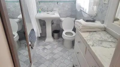 a white bathroom with a sink and a toilet at Amazing Hollywood Bungalow Three! in Los Angeles
