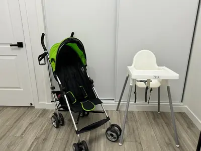 a stroller next to a white table and a chair at Modern Home for Large Families by Disney & Knotts in Anaheim
