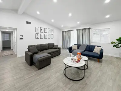 a living room with two couches and a table at Modern Home for Large Families by Disney & Knotts in Anaheim