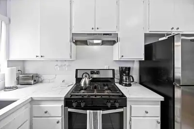 a kitchen with a stove with a tea kettle on it at Elegant Beachside 2 Bed 2 Bath in Long Beach