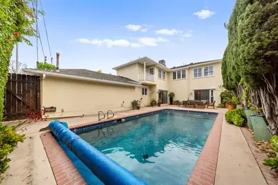 an image of a swimming pool in front of a house at Beverly Hills 6BR Haven w Pool Hot Tub in Los Angeles