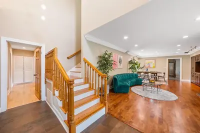a living room with a staircase and a green couch at Beverly Hills 6BR Haven w Pool Hot Tub in Los Angeles