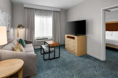 a hotel room with a couch and a tv and a bed at Homewood Suites by Hilton Anaheim Conv Ctr/Disneyland Main in Anaheim