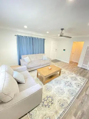 a living room with a couch and a coffee table at HubCityJewel in Compton