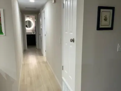 a hallway with white walls and a white floor at In a quiet neighborhood near the Main Street-Room C in Rowland Heights