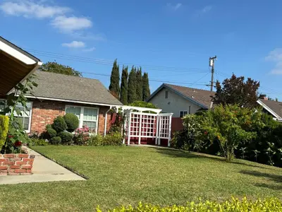 a house with a white gate in a yard at 1 bedroom In a quiet neighborhood near the Main Street- Room A in Rowland Heights
