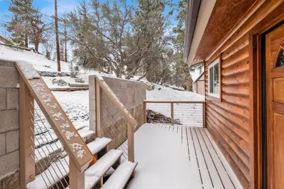 a snow covered stairway leading to a house at Suenos Azules #2517 in Fawnskin
