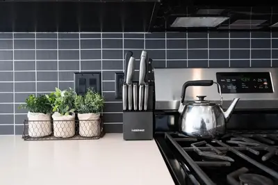 a kitchen counter with a tea kettle and potted plants at Stylish 3BR High-Rise with Pool, Hot Tub & Rooftop Views in Los Angeles