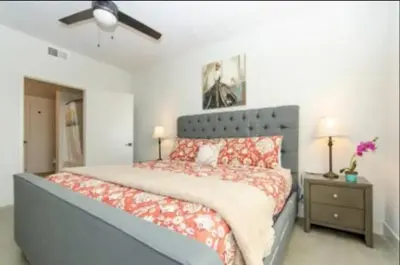 a bedroom with a large bed with red pillows at Cozy 2 Bedroom Apartment Near Disneyland and Anaheim Convention Center in Orange