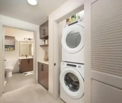 a bathroom with a washer and dryer in a room at Cozy 2 Bedroom Apartment Near Disneyland and Anaheim Convention Center in Orange