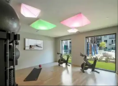 a gym with exercise bikes and lights on the ceiling at Cozy 2 Bedroom Apartment Near Disneyland and Anaheim Convention Center in Orange