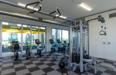 a gym with a checkered floor and tread machines at Snazzy 3 Bedroom High Rise with Pool, Hot Tub and Rooftop Deck in Los Angeles