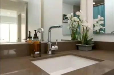 a bathroom counter with a sink and a mirror at Beautiful 3 Bedroom High Rise with Pool, Hot Tub and Rooftop Views in Los Angeles