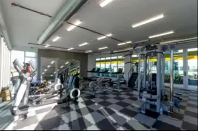 a gym with several treadmills and machines in a room at Cozy 3BR High Rise with Pool with great views in Los Angeles