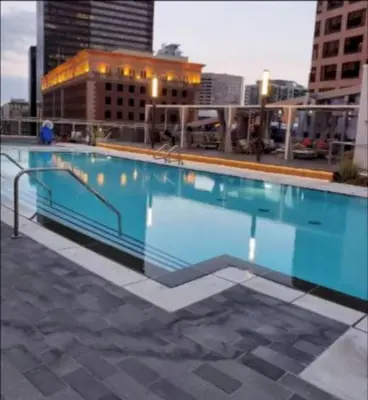 a large blue swimming pool on top of a building at Cozy 3BR High Rise with Pool with great views in Los Angeles