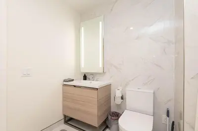 a white bathroom with a sink and a toilet at Cozy 3BR High Rise with Pool with great views in Los Angeles