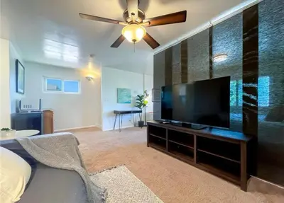 a living room with a large flat screen tv at Hillside-This is a House with 5 master suite in Riverside