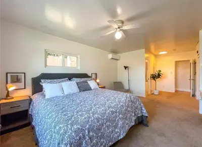 a bedroom with a bed and a ceiling fan at Hillside-This is a House with 5 master suite in Riverside