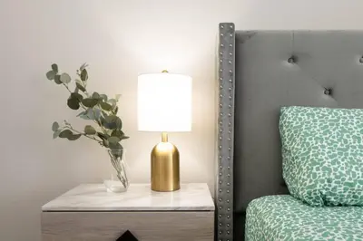a lamp on a table next to a bed at Snazzy 2 Bedroom Pad with Rooftop Pool and Hollywood Sign View in Los Angeles