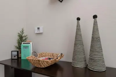 a table with two vases and a basket on it at Snazzy 2 Bedroom Pad with Rooftop Pool and Hollywood Sign View in Los Angeles