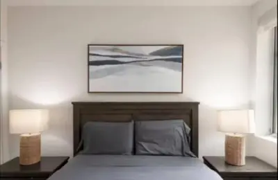 a bedroom with a bed with two nightstands and two lamps at Hosp Walk to Santa Monica Beach Pier in Los Angeles