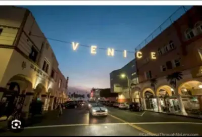 a car driving down a city street with a traffic light at Hosp Walk to Santa Monica Beach Pier in Los Angeles