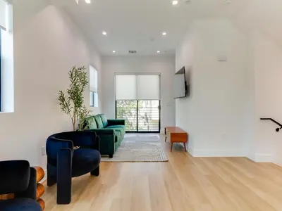 a living room with a green couch and chairs at Modern Luxe Retreat 3-Bedroom #3 in Los Angeles