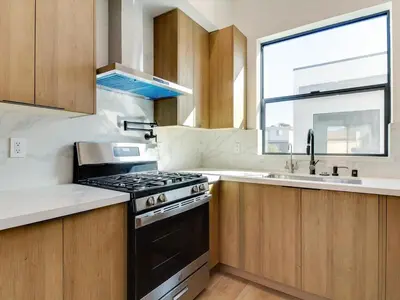 a kitchen with a stove and a sink and a window at Modern Luxe Retreat 3-Bedroom #3 in Los Angeles
