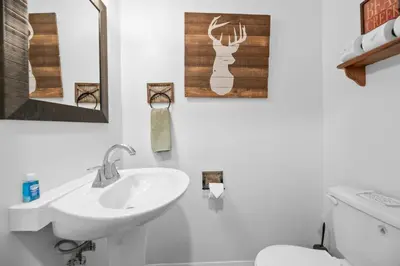 a white bathroom with a sink and a toilet at StoneHauz was built in 1926! It's a REAL CABIN! in Big Bear Lake