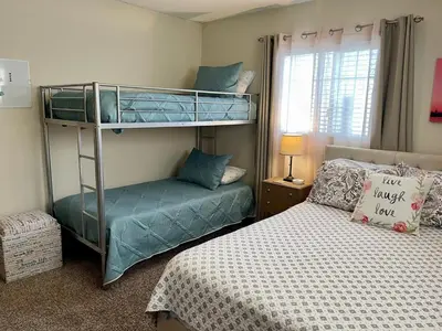 a bedroom with two bunk beds and a bed at Cheerful Single Story 3-bedroom home w pool table in Santa Clarita