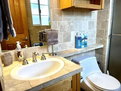 a bathroom with a sink and a toilet at Cheerful Single Story 3-bedroom home w pool table in Santa Clarita
