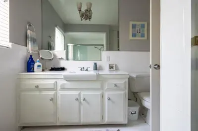 a bathroom with a white sink and a toilet at Steps to Ocean Bliss in Long Beach