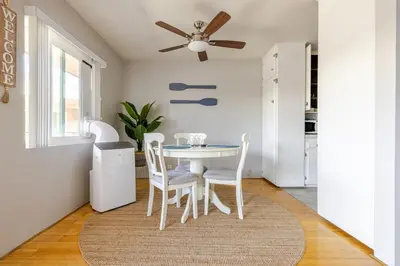 a dining room with a table and chairs and a ceiling fan at Steps to Ocean Bliss in Long Beach